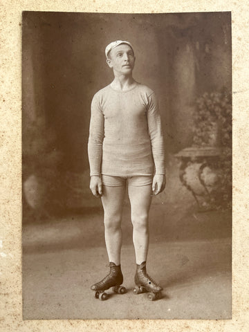 Large cabinet photo of a nobly aloof man in short-shorts on roller skates