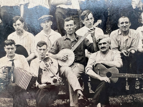 RPPC real albumen photograph of a men's folk band motley choir musician group photo extravaganza, ft. banjo, fiddle, accordion, guitar, hats, grimaces