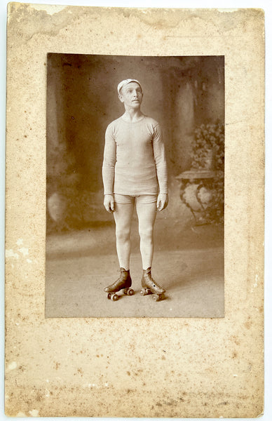 Large cabinet photo of a nobly aloof man in short-shorts on roller skates