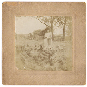 Occupational portrait of a woman feeding chickens on a farm (cabinet card photograph)