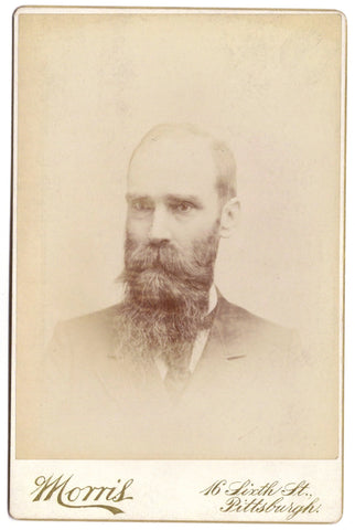 Studio portrait of a suspiciously wide-eyed man (cabinet card photograph)