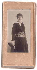 Narrow portrait of a woman in a paper/card mount