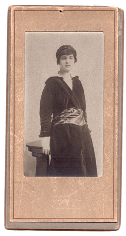 Narrow portrait of a woman in a paper/card mount