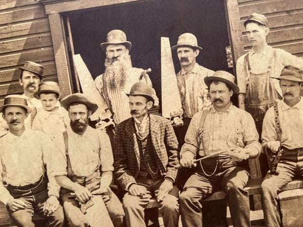 Occupational portrait of nine carpenters and a child