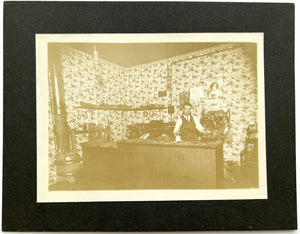 Photograph of a cobbler at the repair counter, ca. 1930s