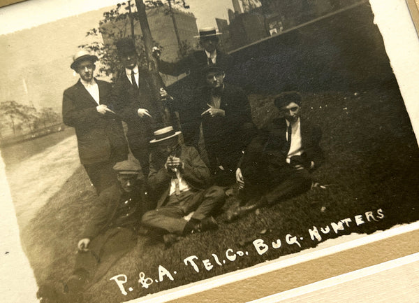 Photograph of seven young men, "P. & A .Tel. Co. Bug Hunters" (RPPC)