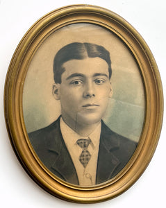 Framed oval crayon portrait of a young man about to say something