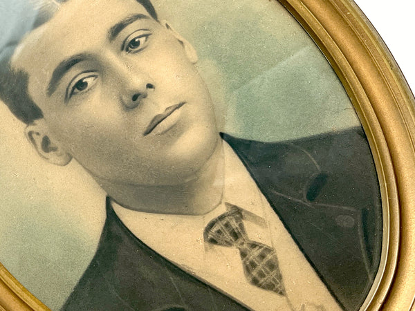 Framed oval crayon portrait of a young man about to say something