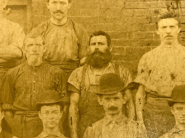 Occupational portrait of twenty-seven men outside an abattoir(?)