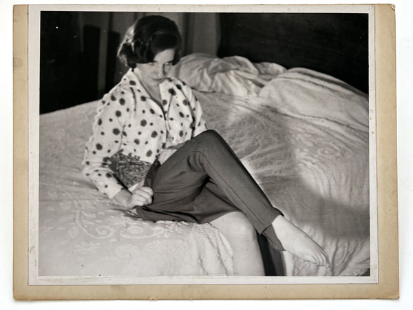12 photographs of the same woman in various stages of enthusiasm and undress