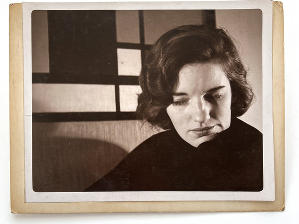 12 photographs of the same woman in various stages of enthusiasm and undress