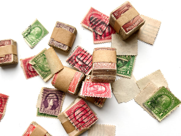 Wooden slide-top box full of hundreds of U.S., British and Belgian stamps.