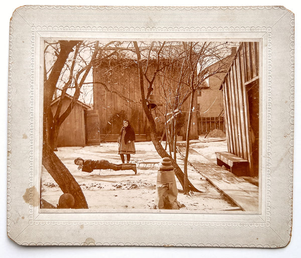 Two children and a sled, ca. 1900