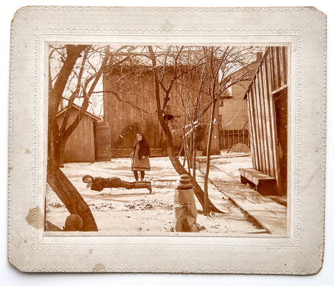 Two children and a sled, ca. 1900