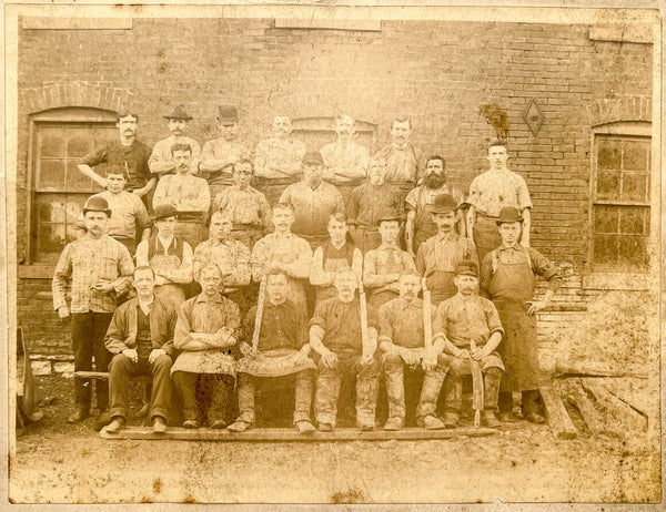 Occupational portrait of twenty-seven men outside an abattoir(?)