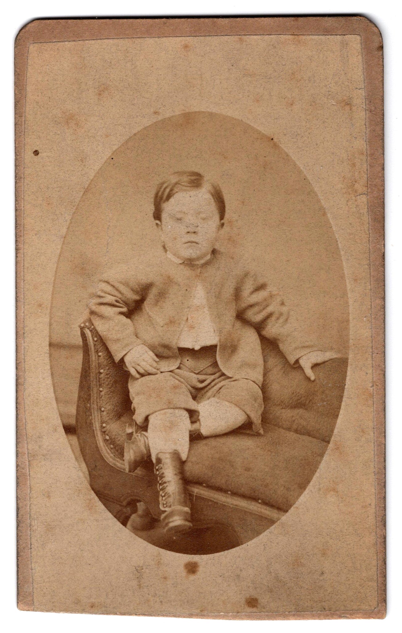 Studio portrait of a boy with his eyes closed (Victorian post-mortem photography)