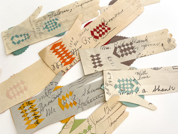 Collection of 22 woven paper pockets and heart-in-hand love tokens, ca. 1927