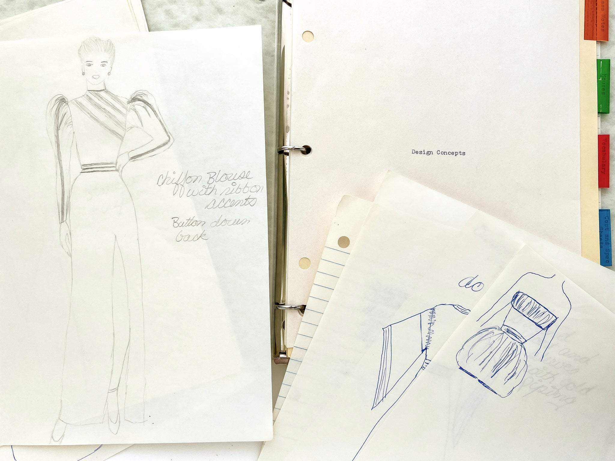 Design Concepts Binder notebook from introductory fashion course, with design sketches and mockups with